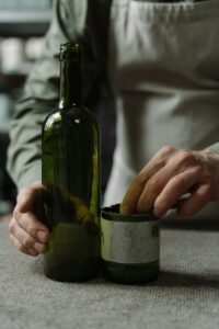 A craftsman transforms glass bottles into art using sustainable techniques.