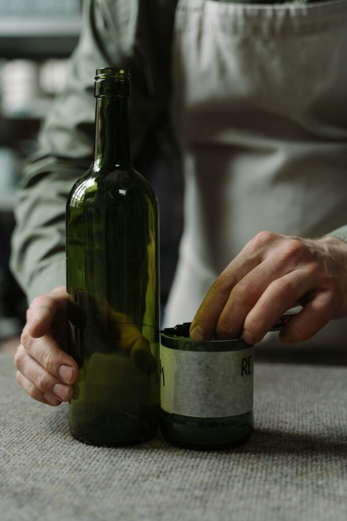 A craftsman transforms glass bottles into art using sustainable techniques.